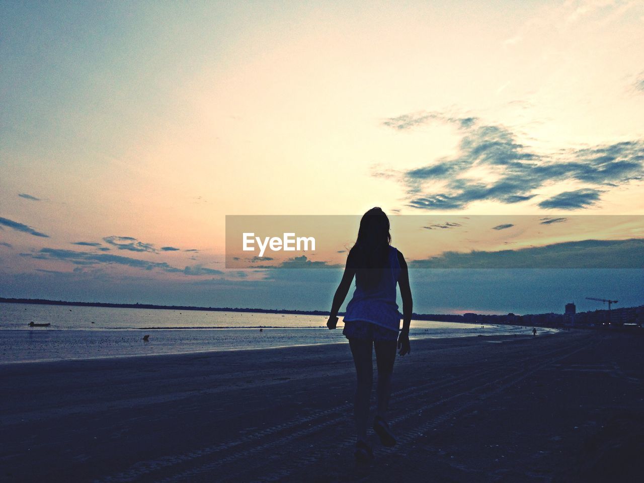 WOMAN STANDING ON BEACH