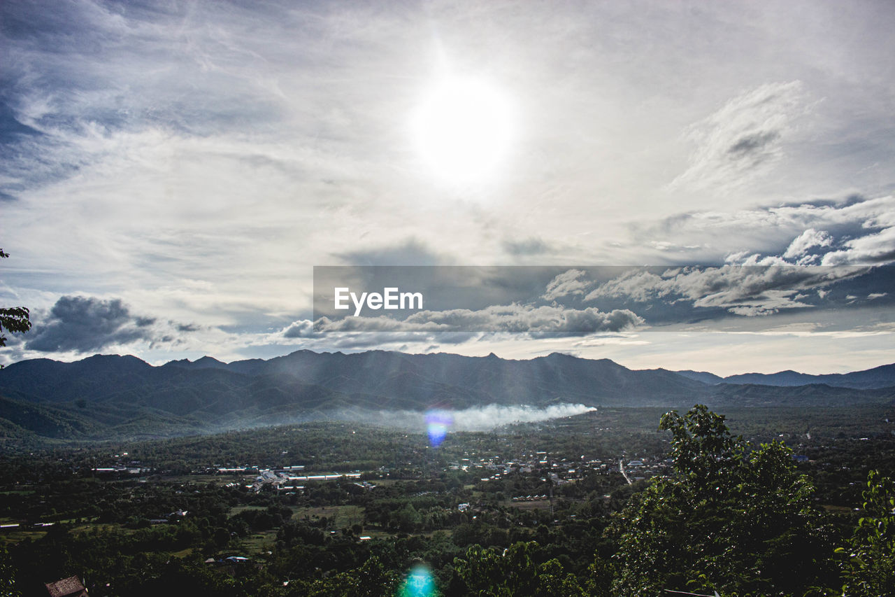 SCENIC VIEW OF MOUNTAINS AGAINST BRIGHT SKY