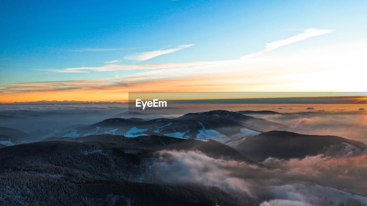 Scenic view of mountains against sky during sunset