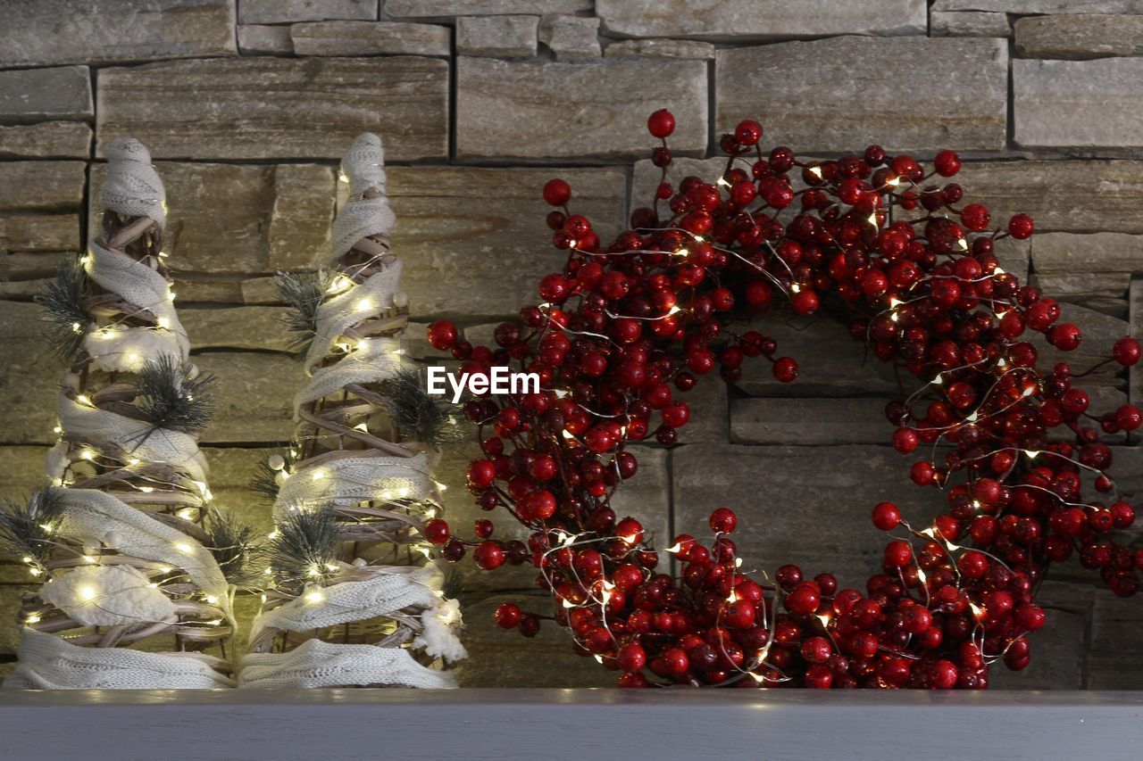 Christmas decorations on table against wall