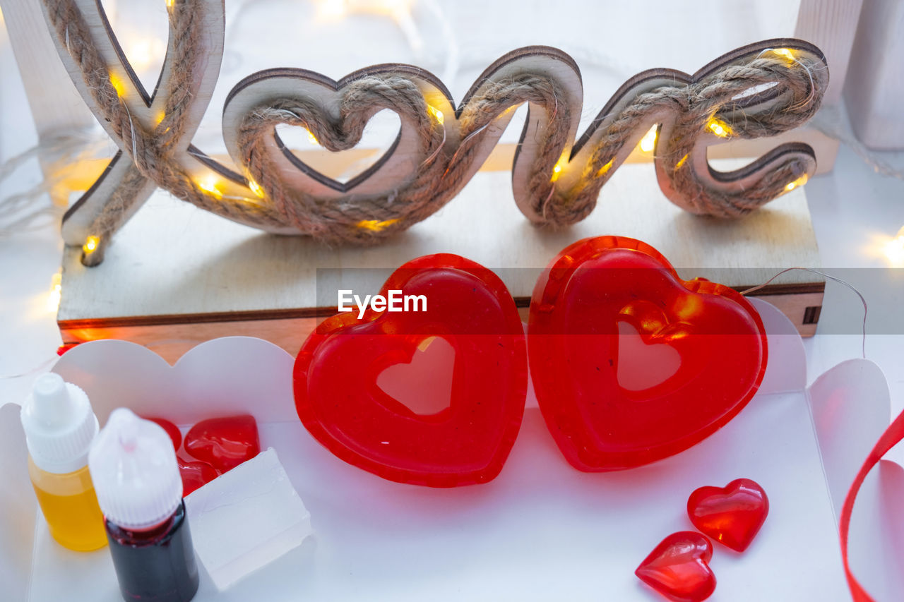 heart shape, heart, red, love, no people, font, positive emotion, indoors, sweet food, valentine's day, emotion, food and drink, still life, sweet, orange, food, studio shot