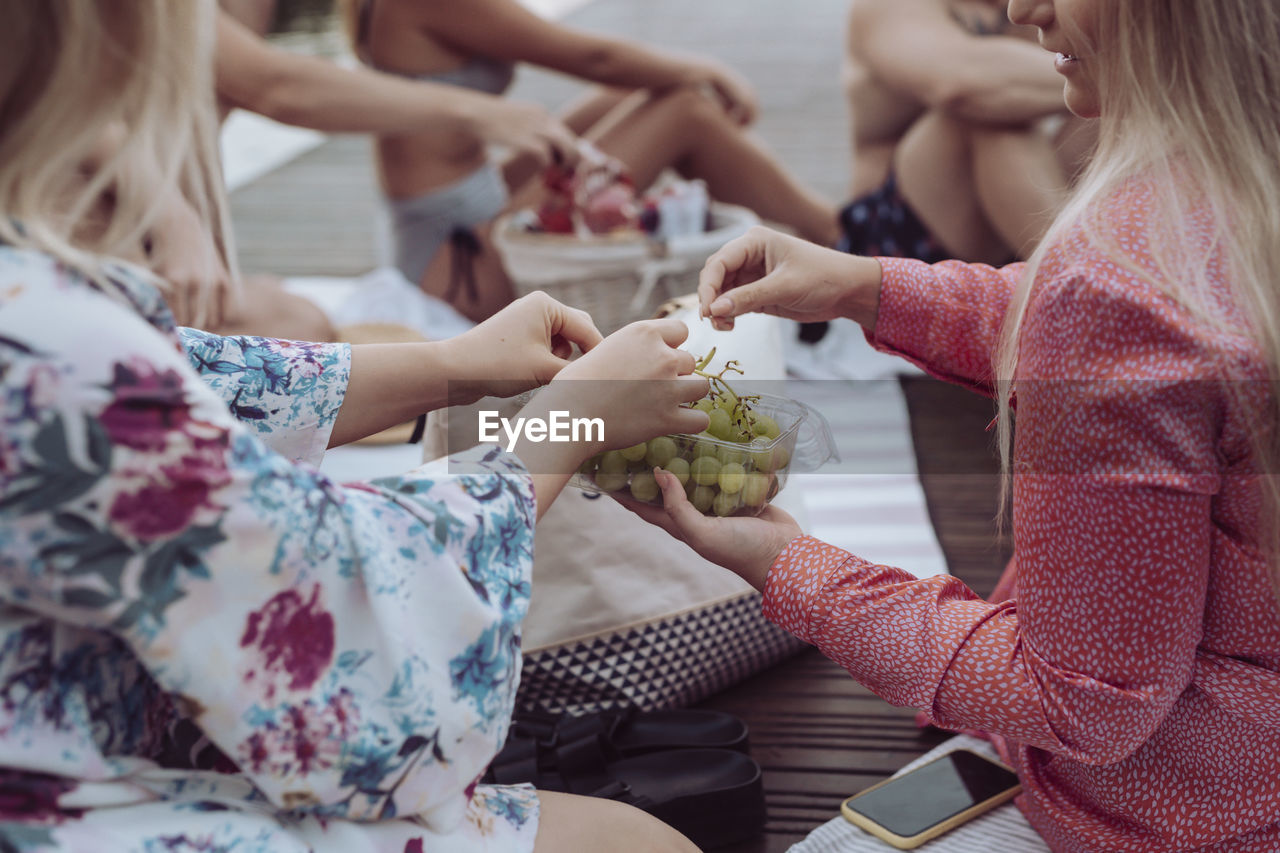 Women's hands holding grapes