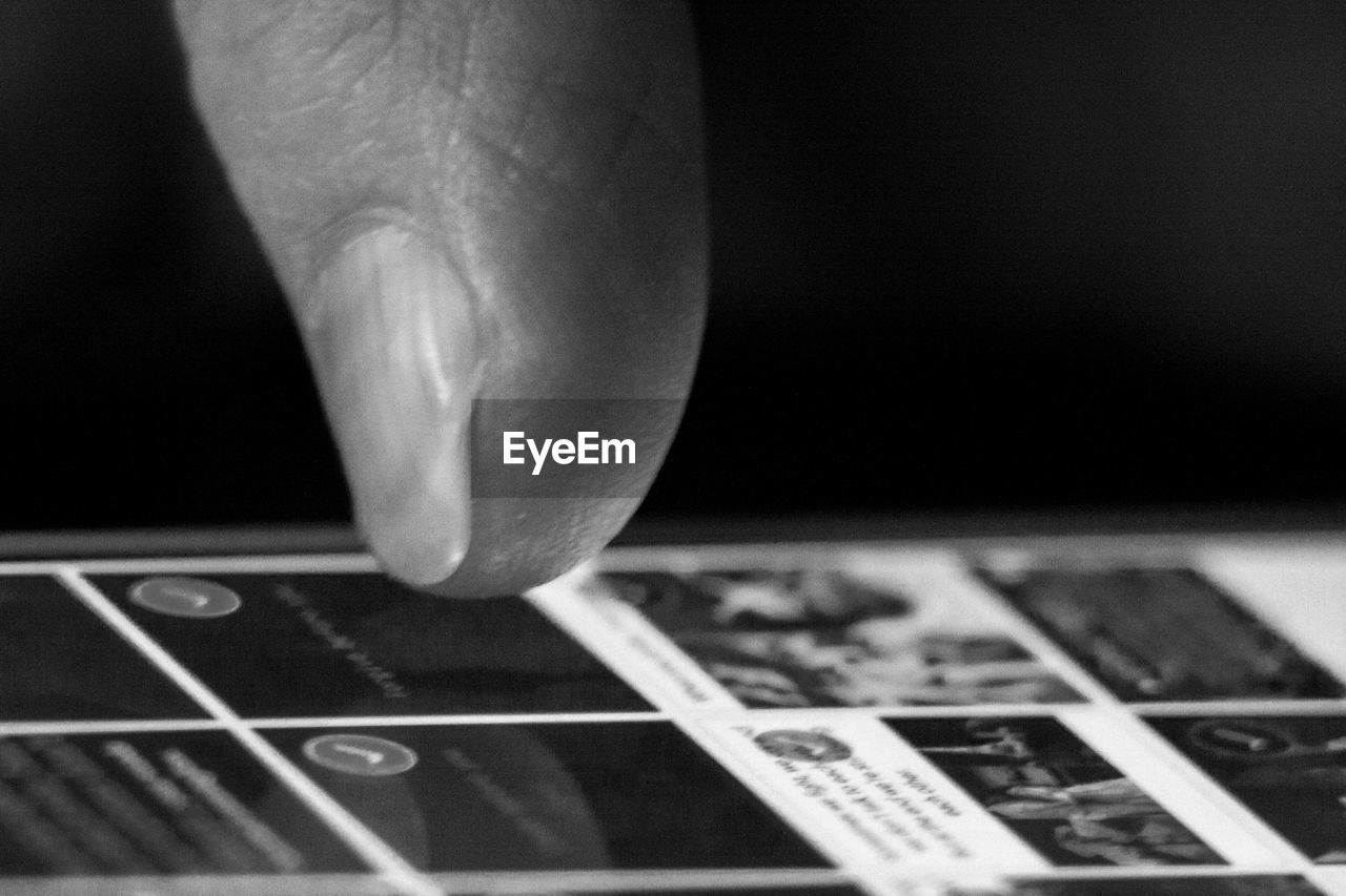 EXTREME CLOSE UP OF HUMAN HAND HOLDING CAMERA