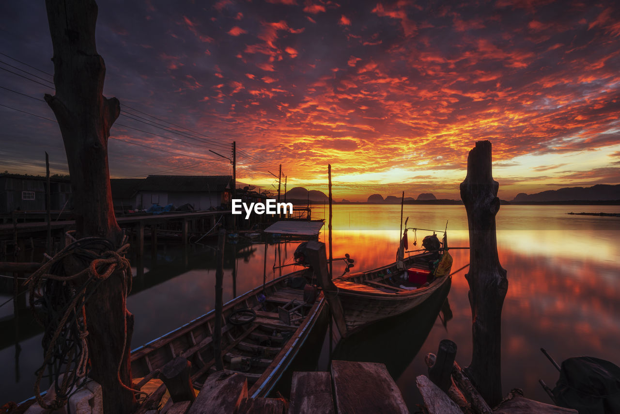 Boats moored at sea during sunset