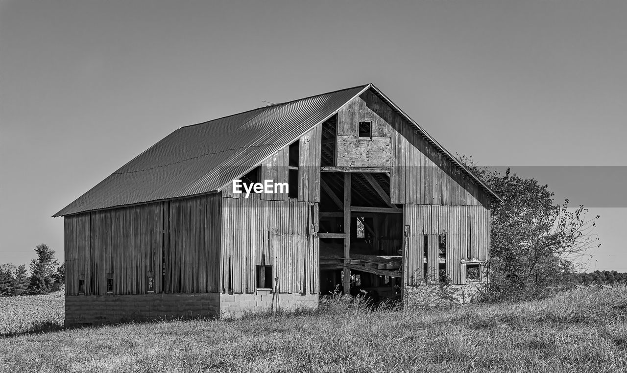 Exterior of house on field against clear sky