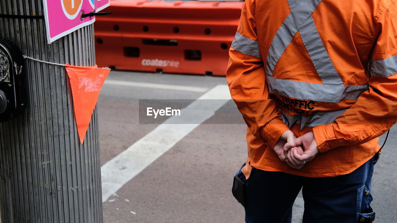 Midsection of man on road