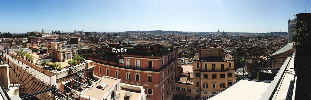 Panoramic shot of townscape against clear blue sky