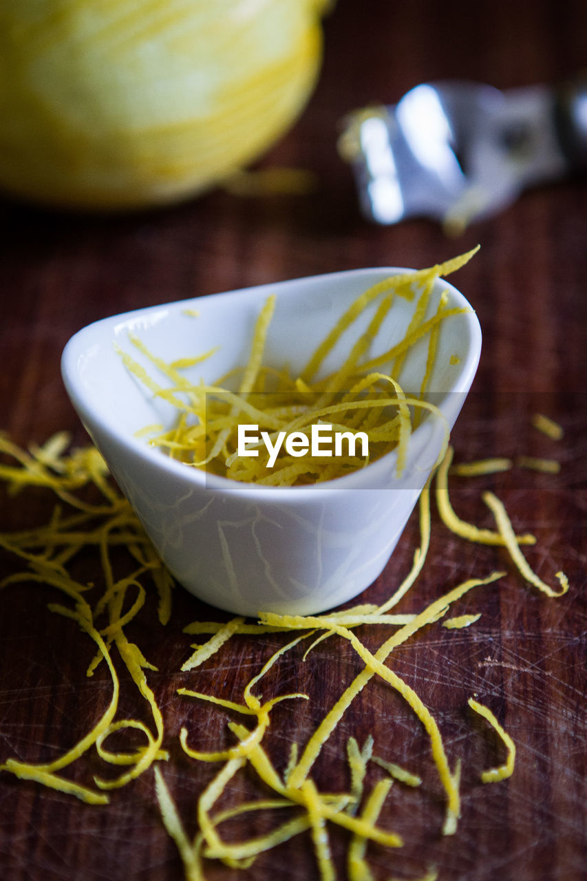 Close-up of shattered lemon in bowl on table