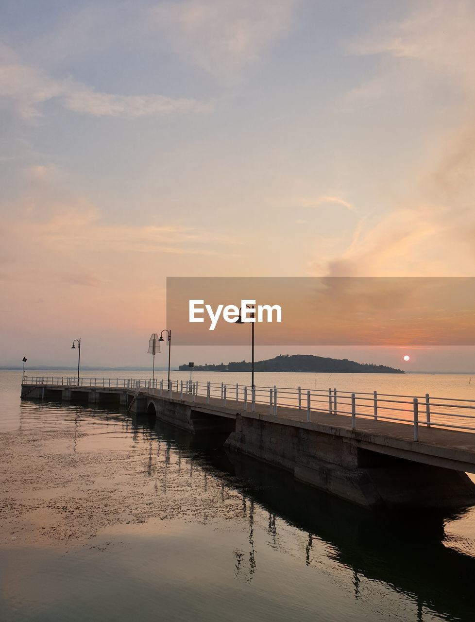 PIER ON SEA AGAINST SKY AT SUNSET