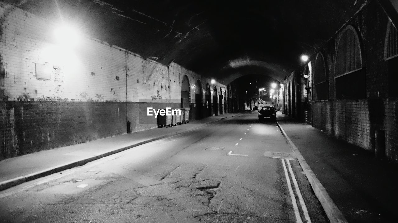 Car in illuminated tunnel