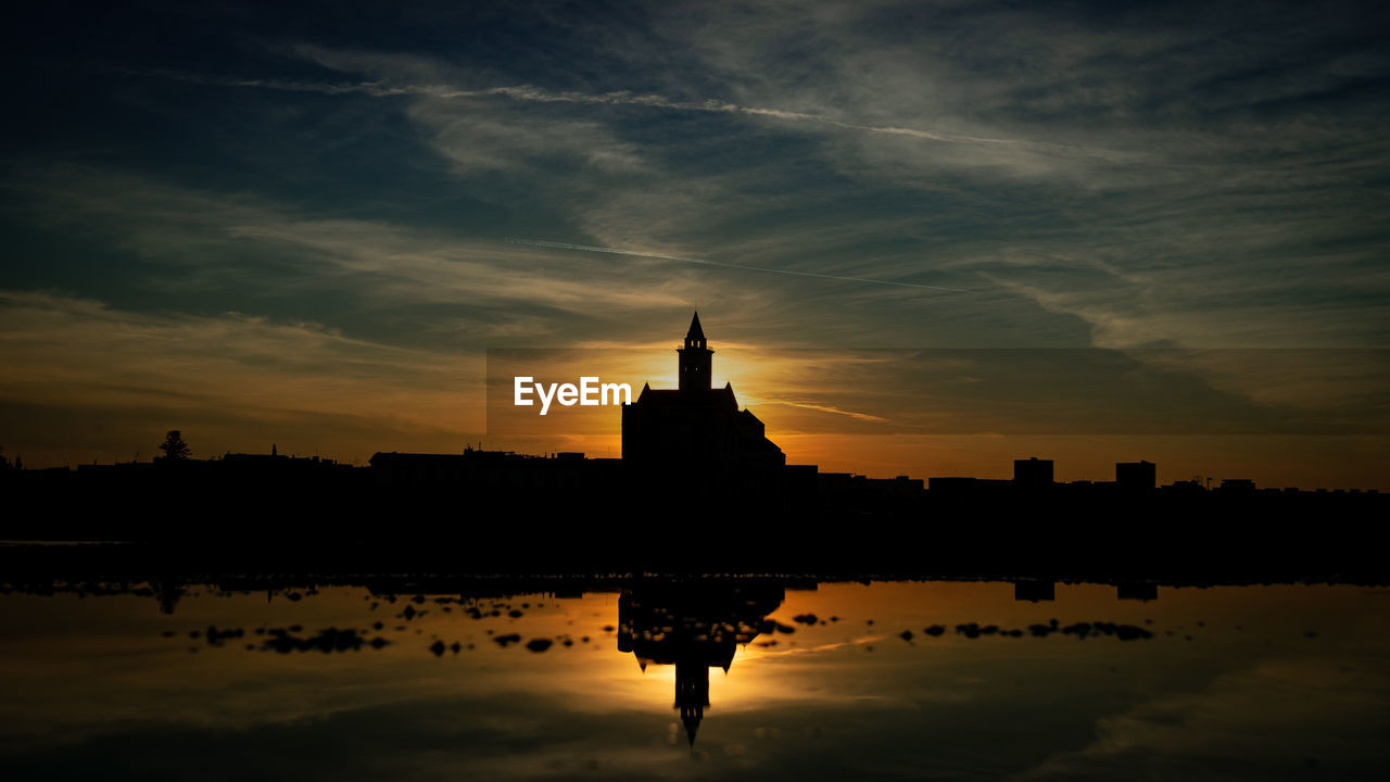 reflection, sky, architecture, dawn, built structure, water, horizon, evening, sunset, building exterior, travel destinations, building, cloud, nature, silhouette, religion, darkness, city, lake, afterglow, sunlight, travel, no people, history, belief, skyline, the past, temple - building, place of worship, outdoors, landscape, spirituality, beauty in nature, sun, tower, tourism, tranquility