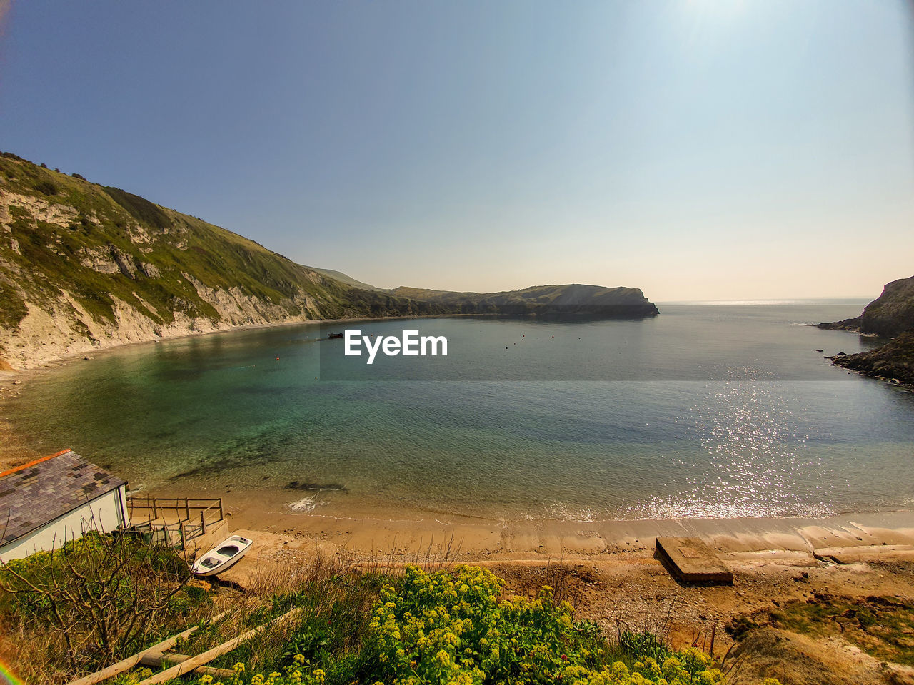 Scenic view of sea against clear sky - lulworth cove uk