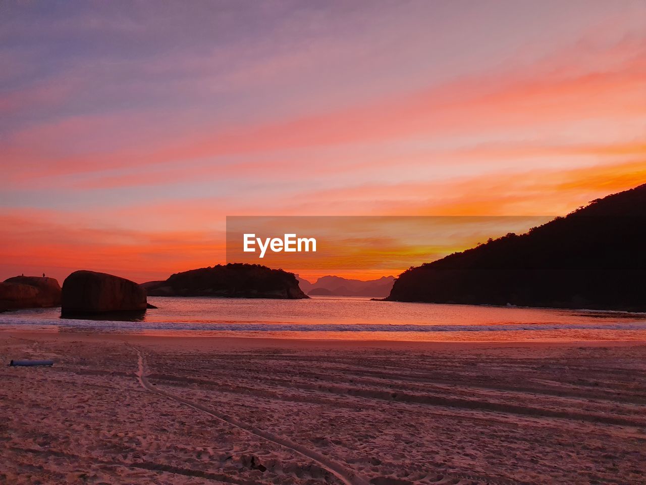 Scenic view of sea against romantic sky at sunset