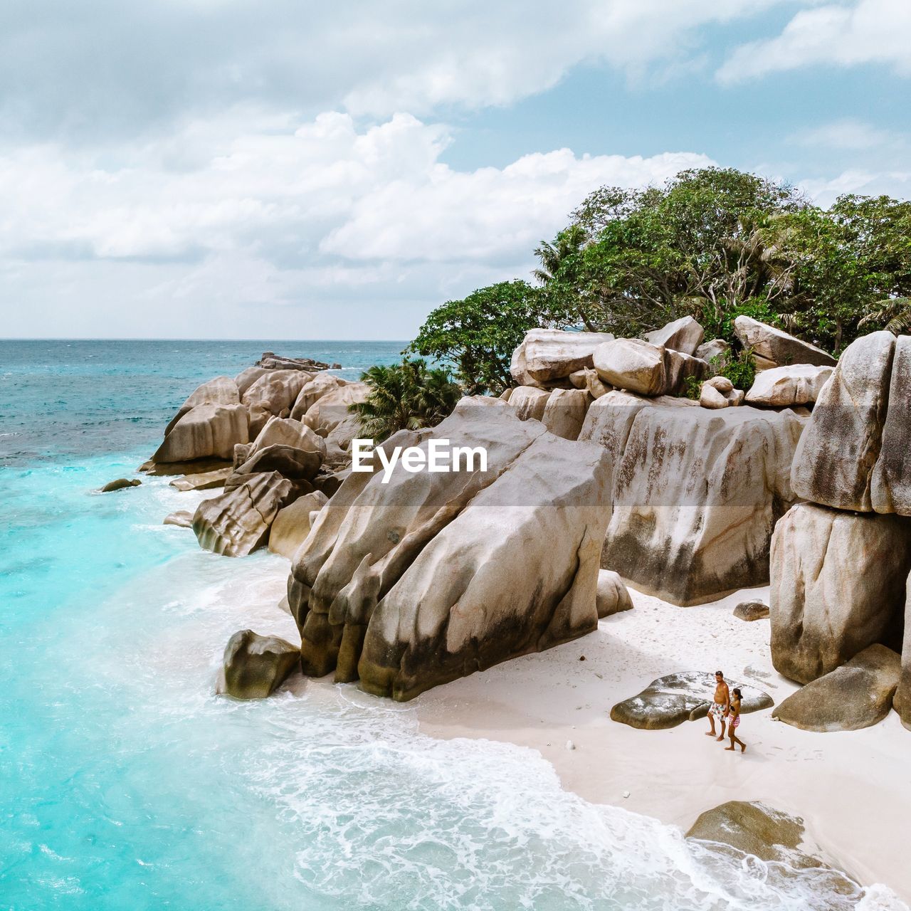 ROCKS ON SHORE AGAINST SKY