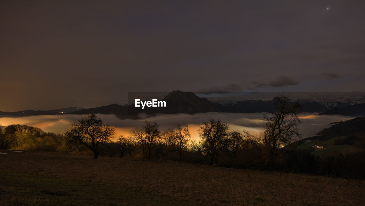 Scenic view of field against sky during sunset