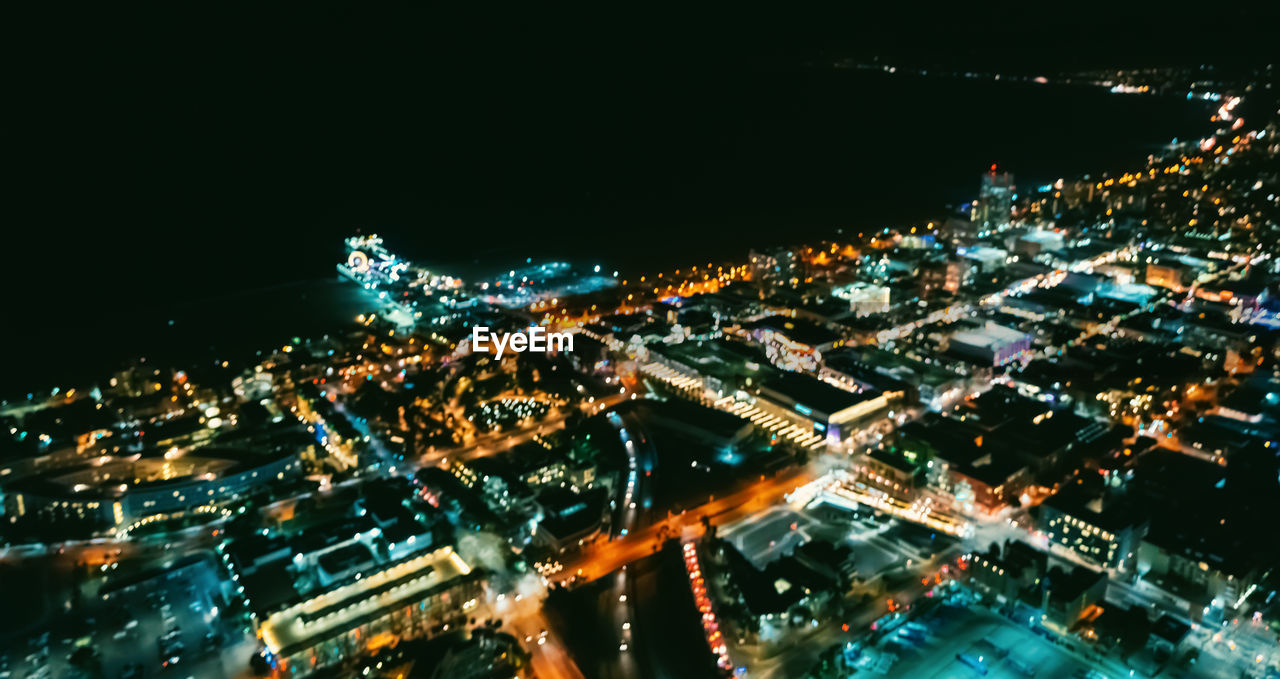 HIGH ANGLE VIEW OF ILLUMINATED CITY BUILDINGS