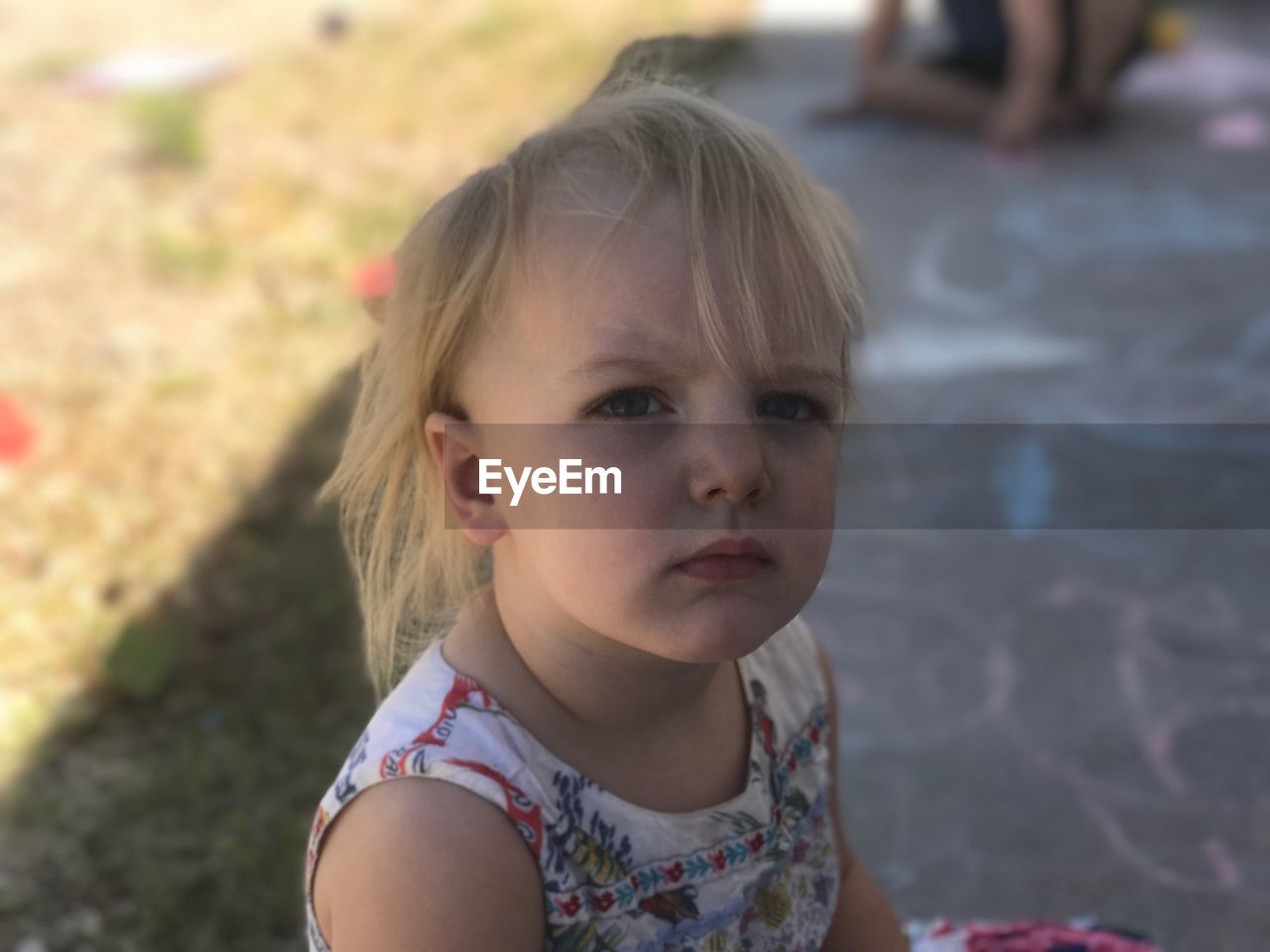 High angle portrait of girl sitting outdoors