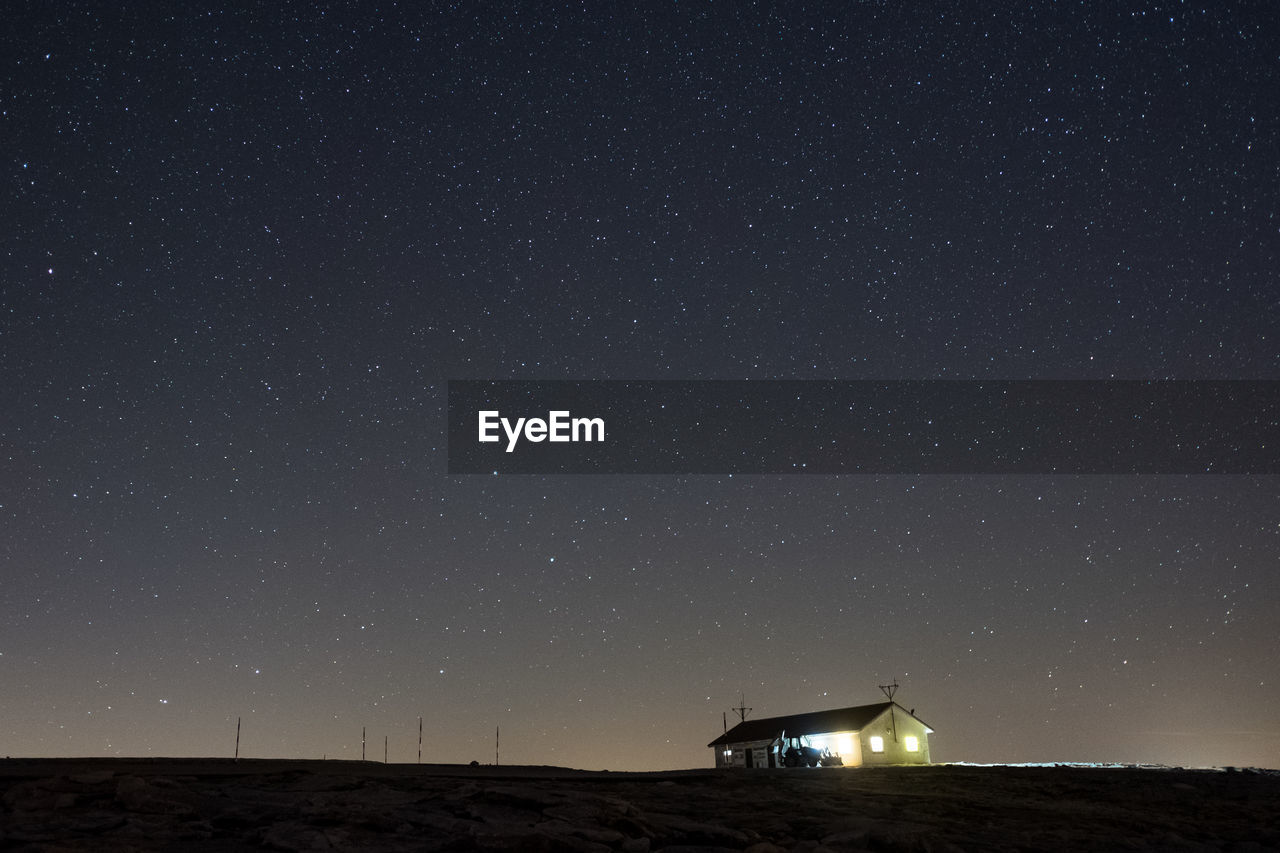 BUILT STRUCTURE AGAINST STAR FIELD AT NIGHT