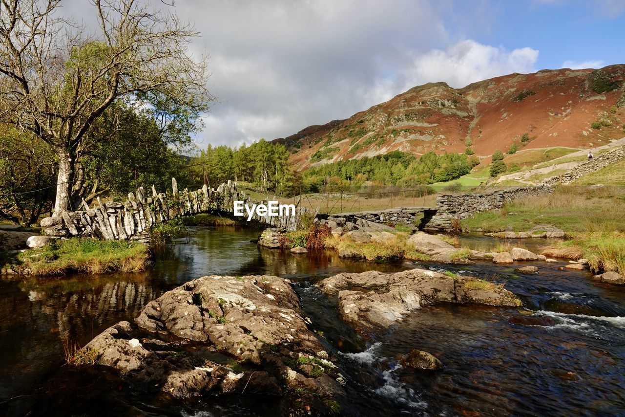 nature, water, wilderness, landscape, sky, river, environment, scenics - nature, cloud, tree, rock, autumn, plant, beauty in nature, land, mountain, no people, travel destinations, travel, valley, reflection, tranquility, architecture, stream, non-urban scene, outdoors, tourism, tranquil scene, forest, day, built structure, pinaceae