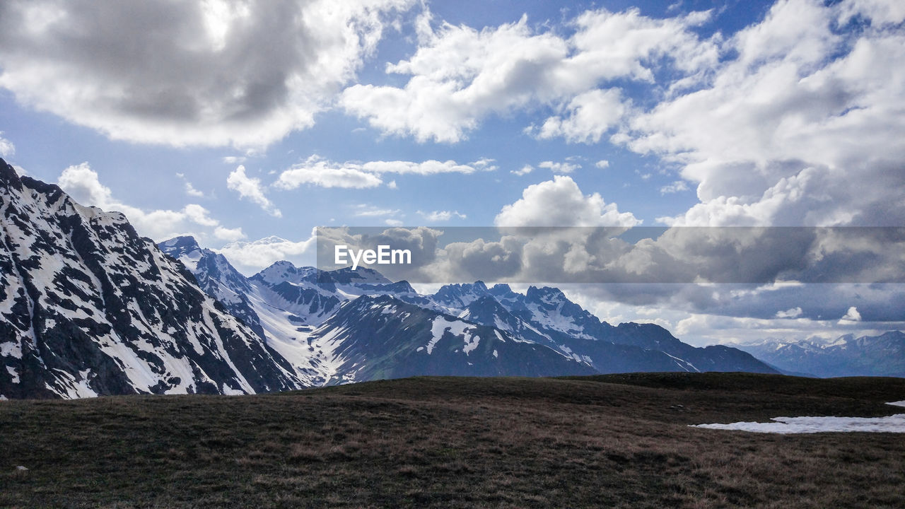 Scenic view of snowcapped mountains against sky