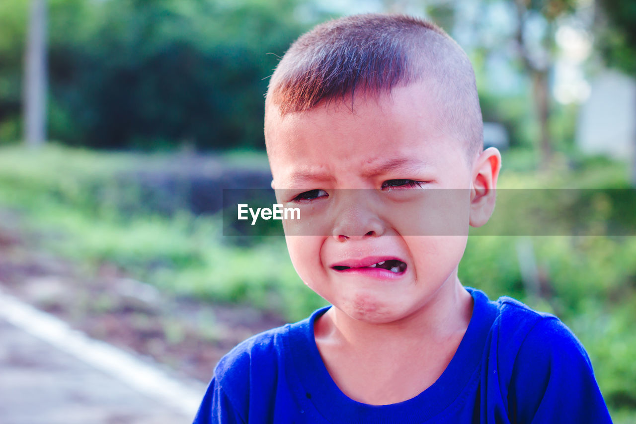 Boy looking away while crying