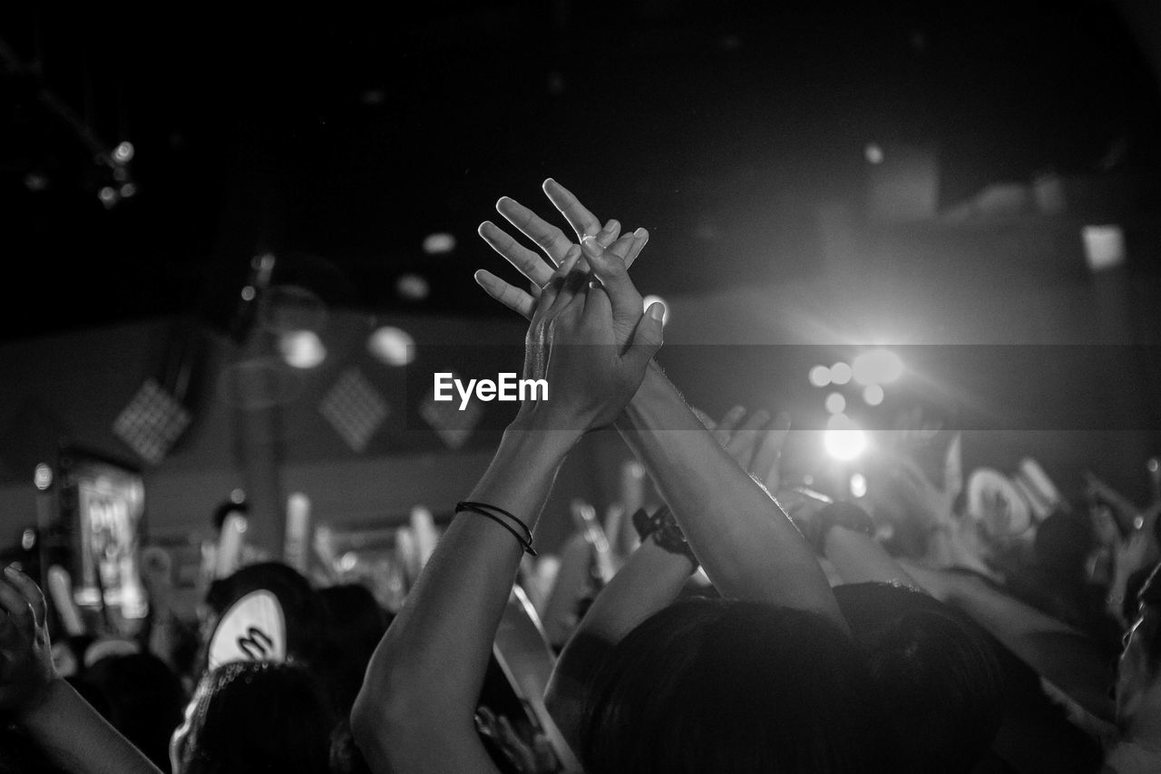 People clapping during event at night