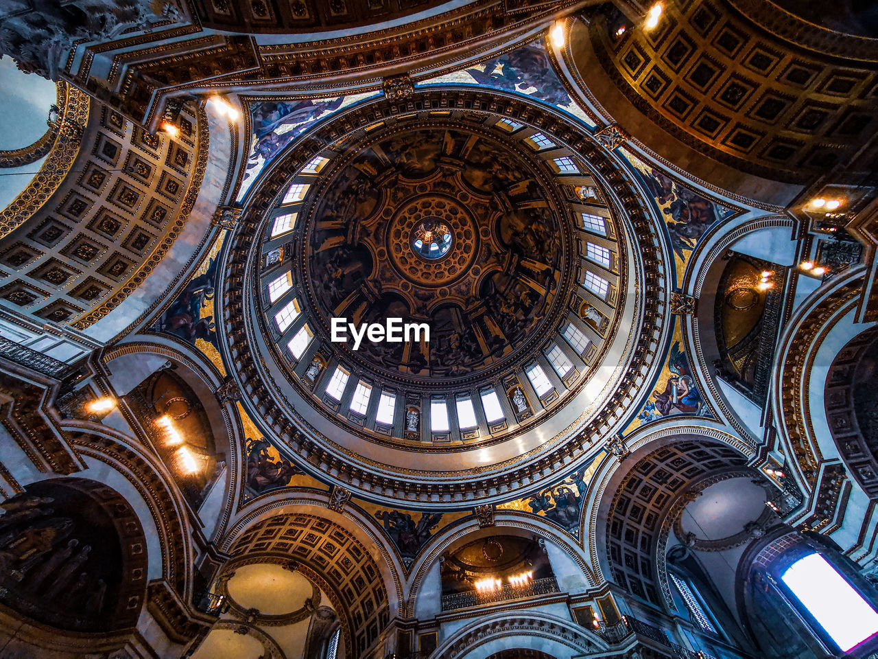 LOW ANGLE VIEW OF ILLUMINATED BUILDING CEILING