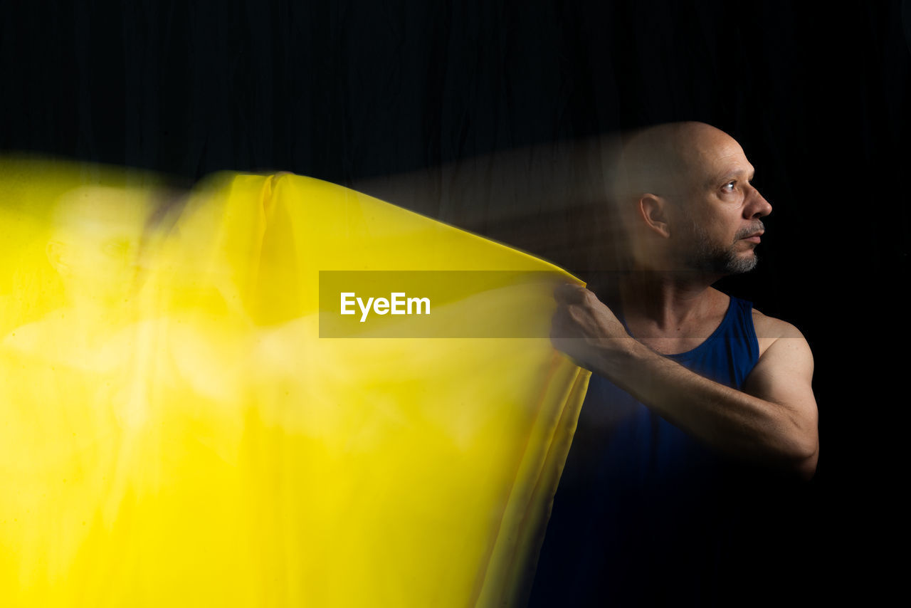 Time lapse view of man moving a rag. long exposure, motion blur. 