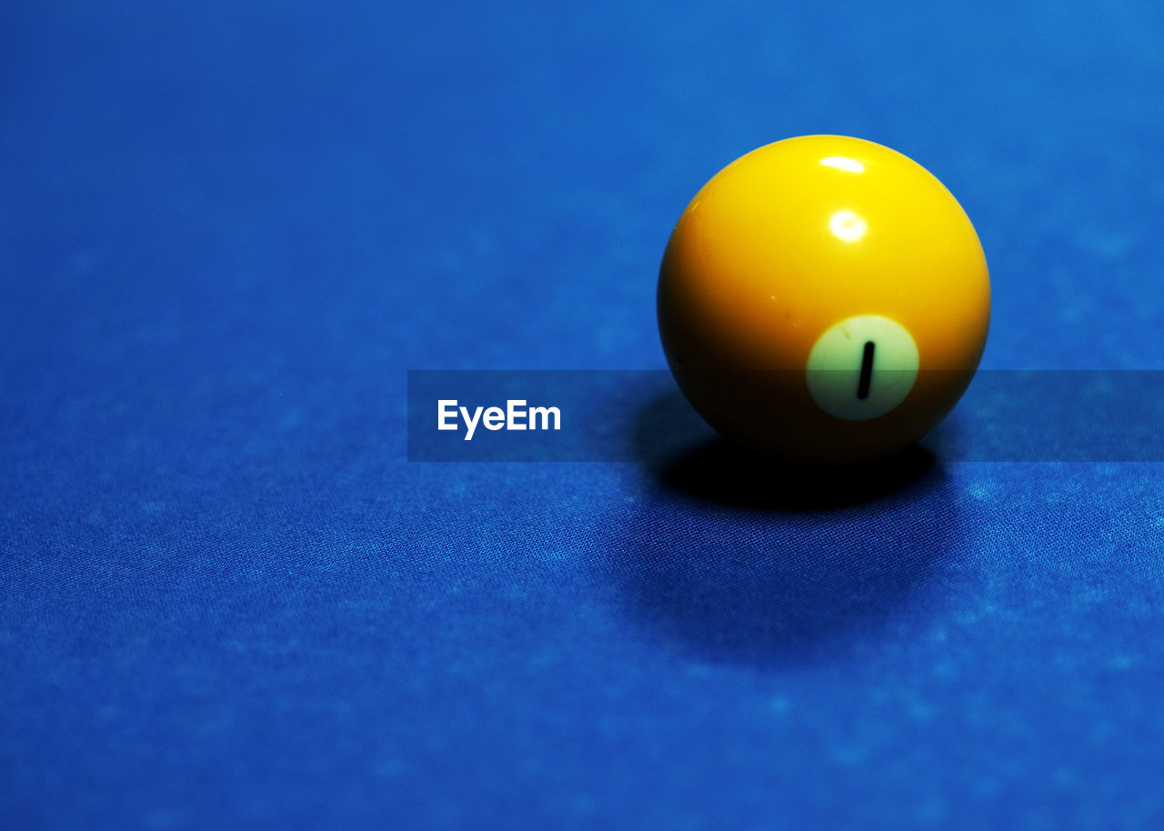 High angle view of yellow pool ball on table