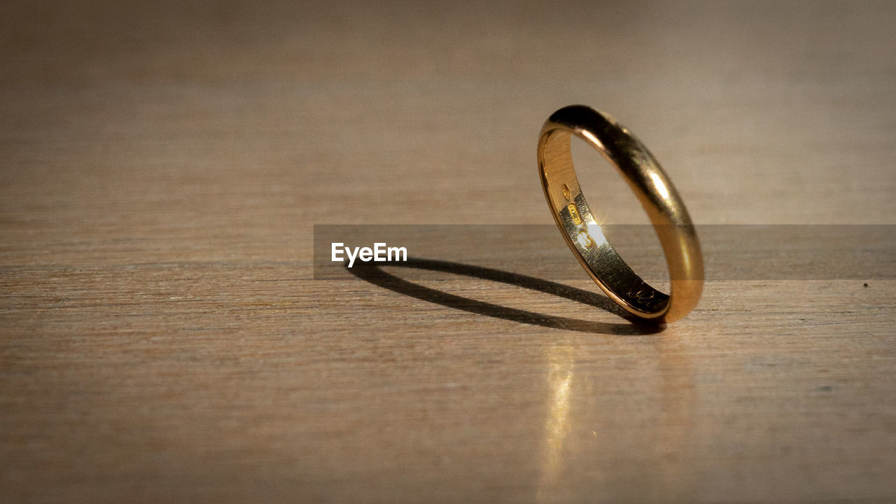 Close-up of wedding rings on table