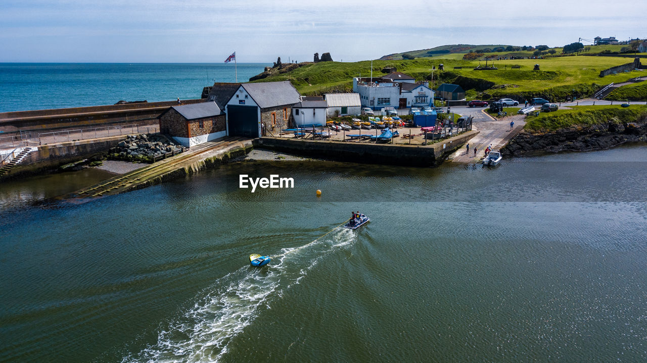 High angle view of houses in town against sea