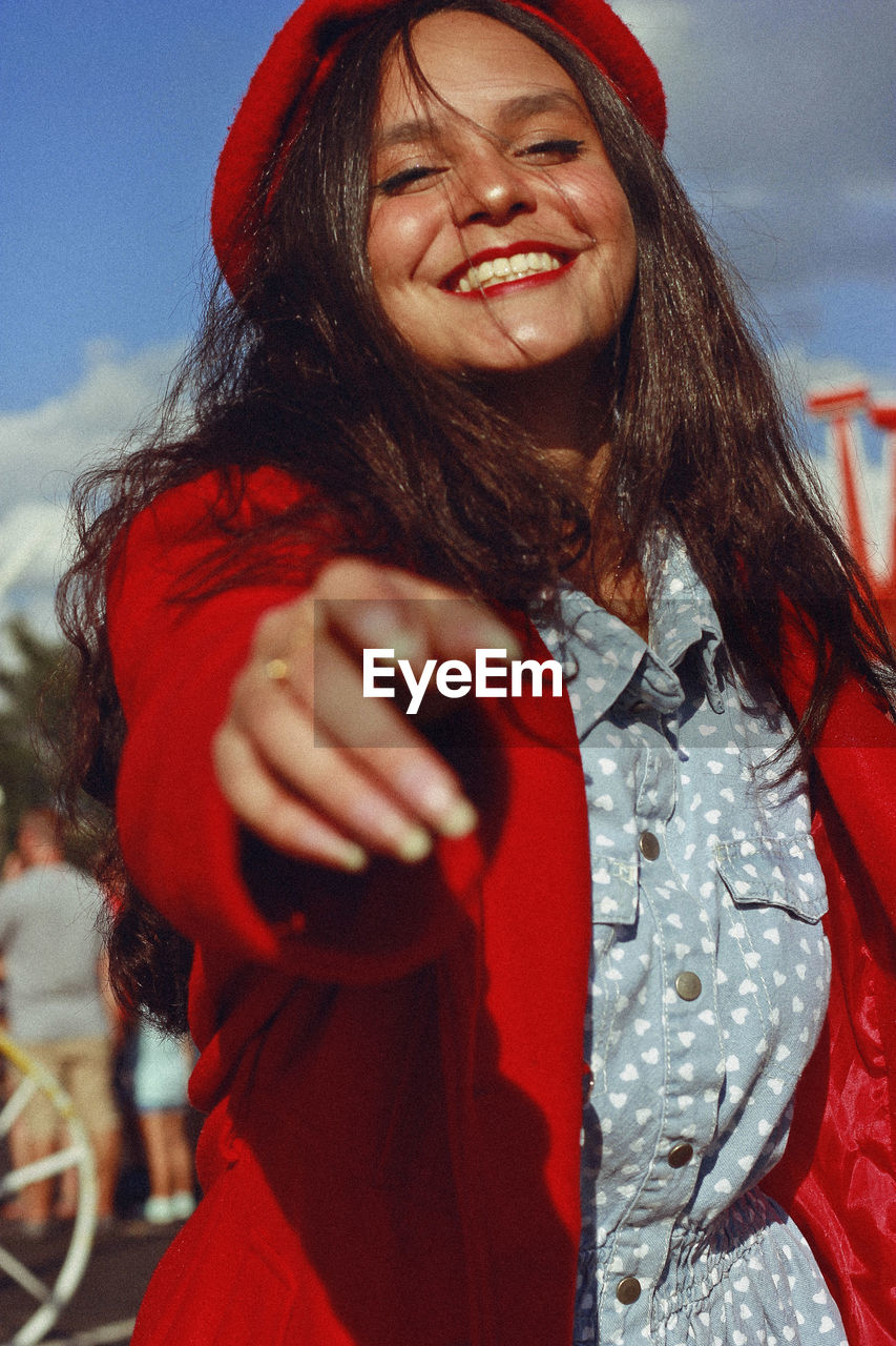 Portrait of smiling teenager girl standing on street