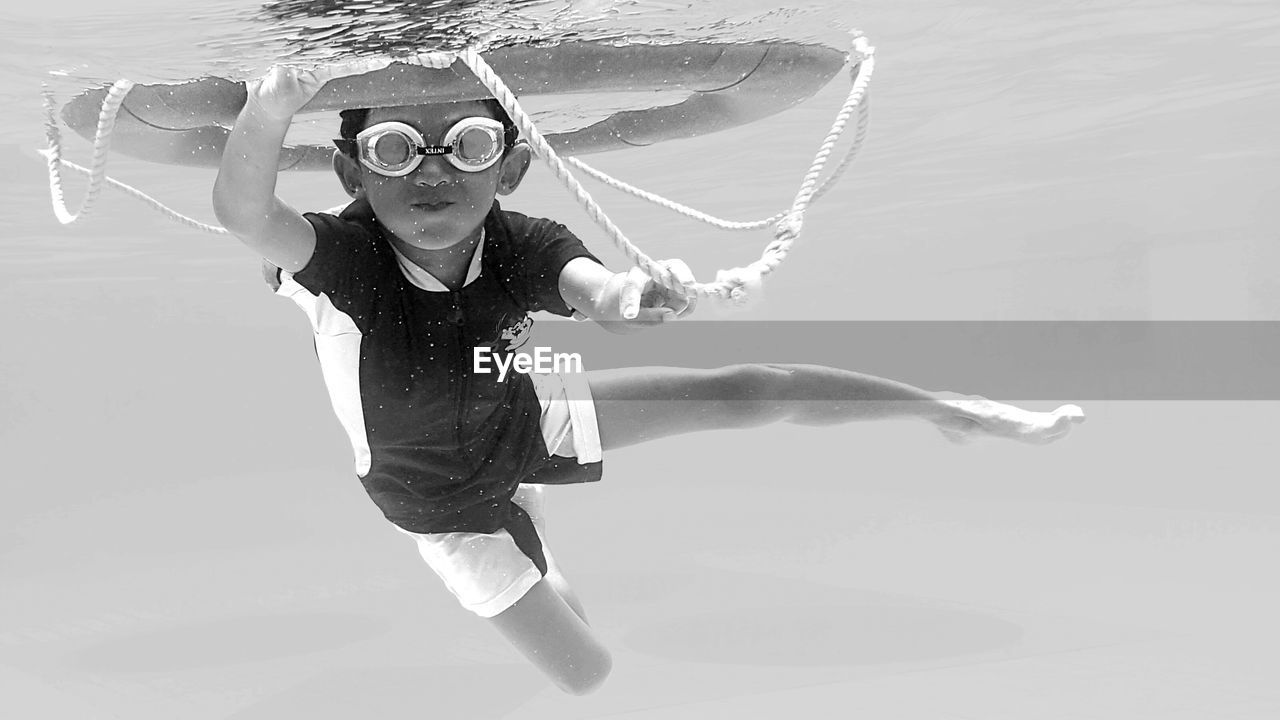 Low angle view of boy swimming in pool