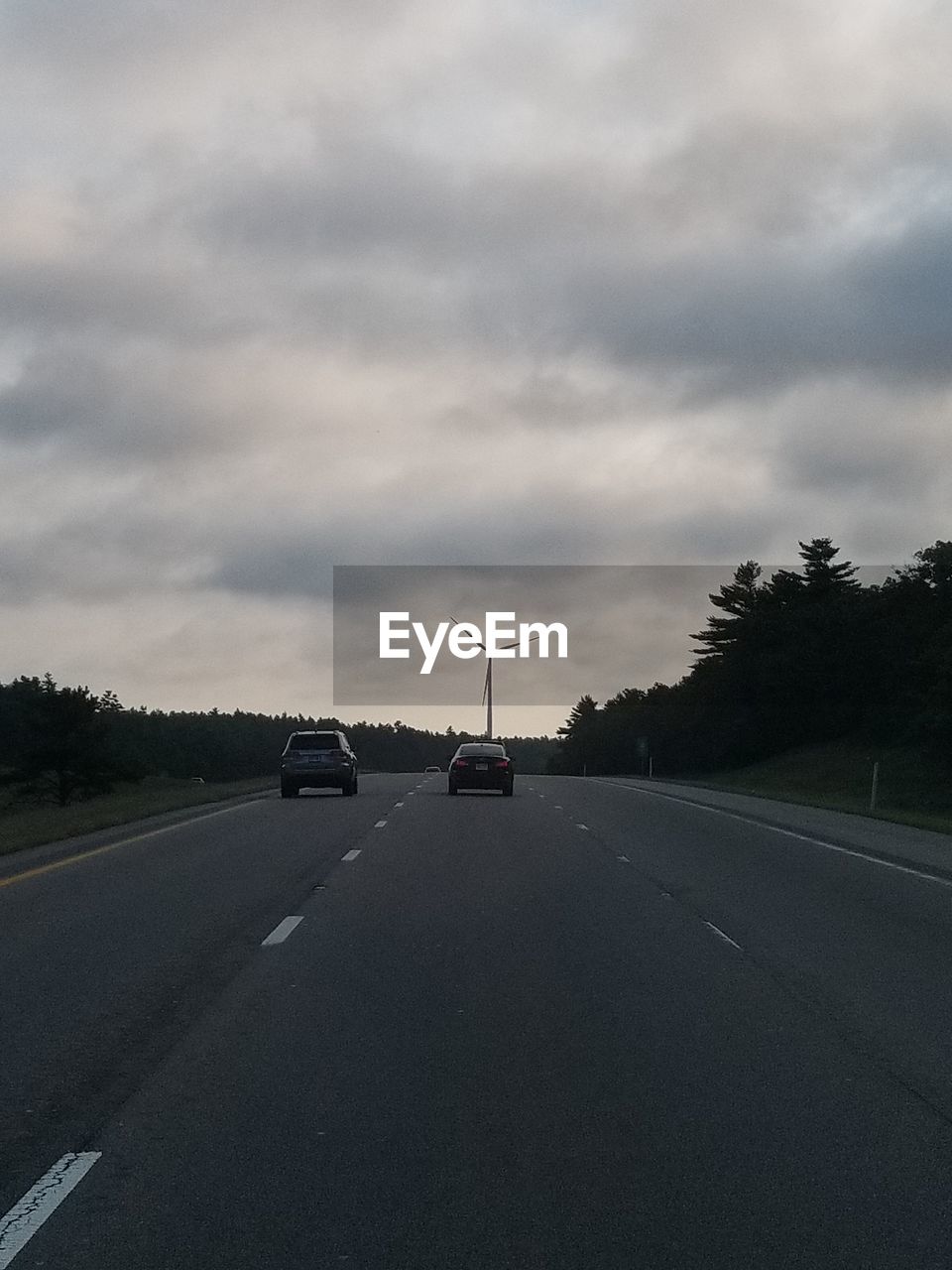 CAR ON ROAD AGAINST SKY