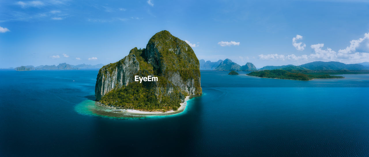 Aerial view of sea and mountain against sky