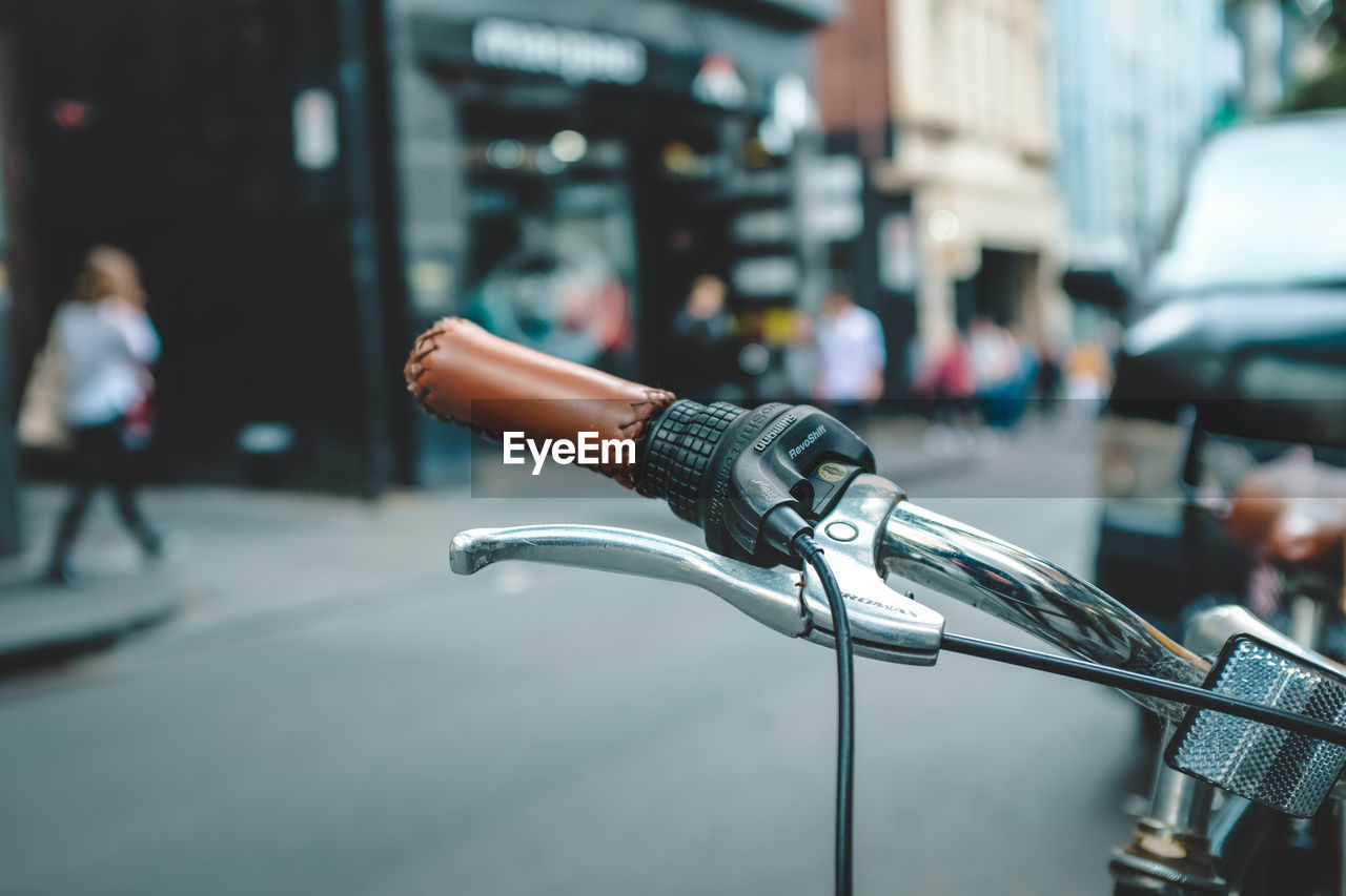 CLOSE-UP OF BICYCLE PARKED ON STREET