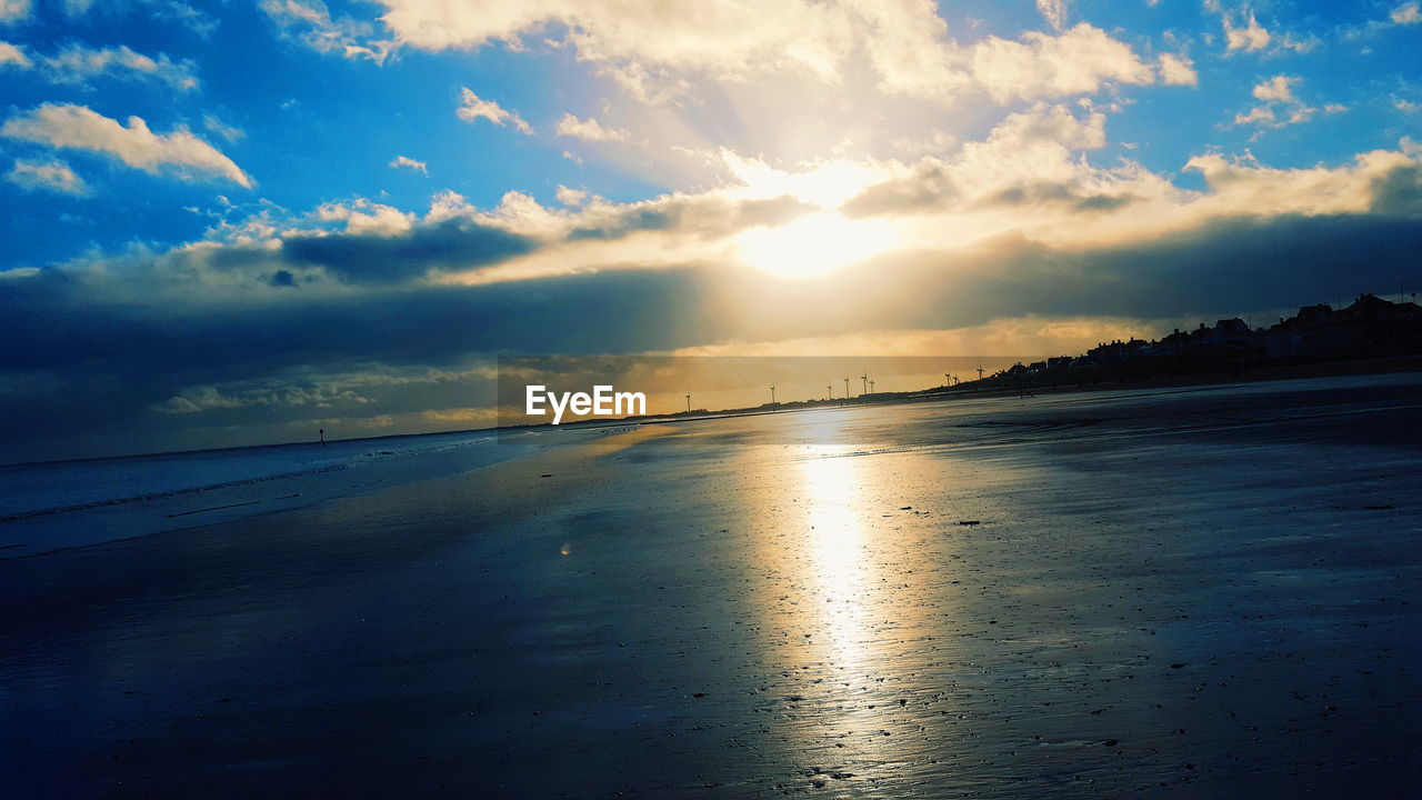 Scenic view of beach against sky during sunset