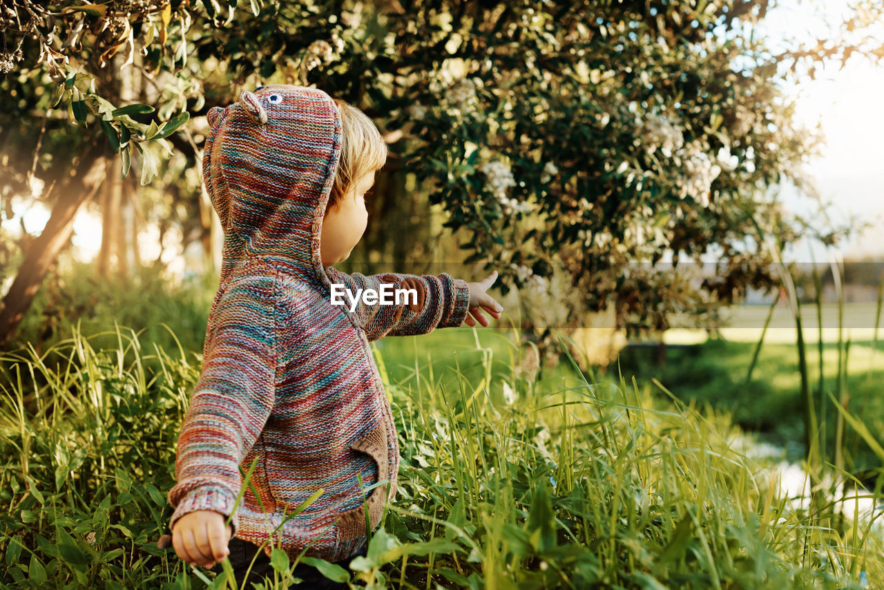 Rear view of girl on field