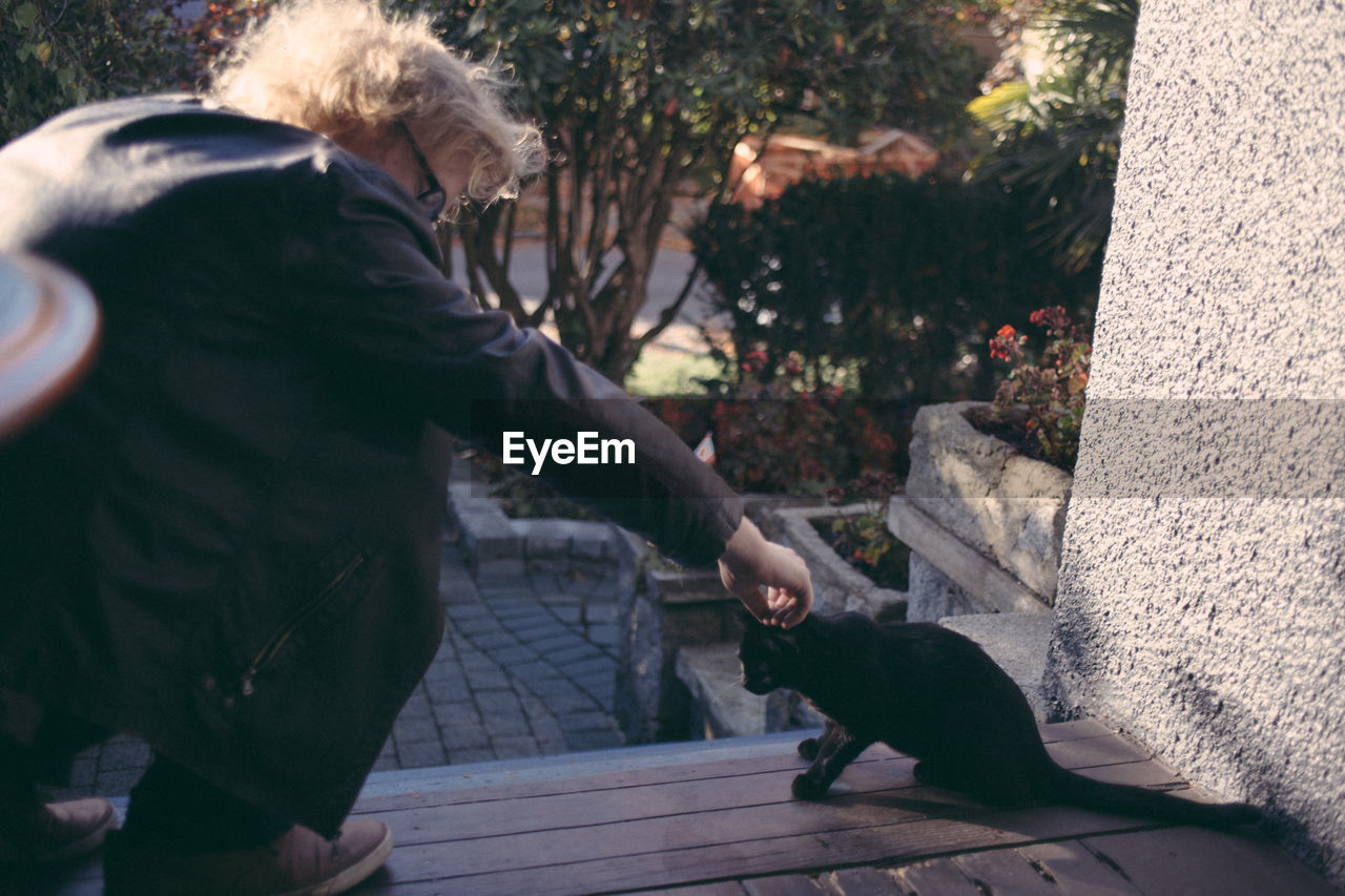 SIDE VIEW OF A DOG WITH CAT ON FLOOR