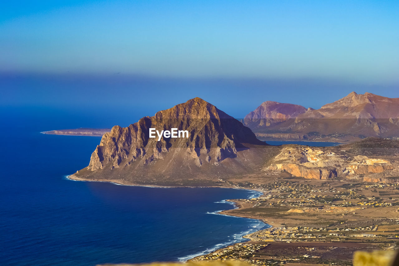 Scenic view of sea and mountains against sky