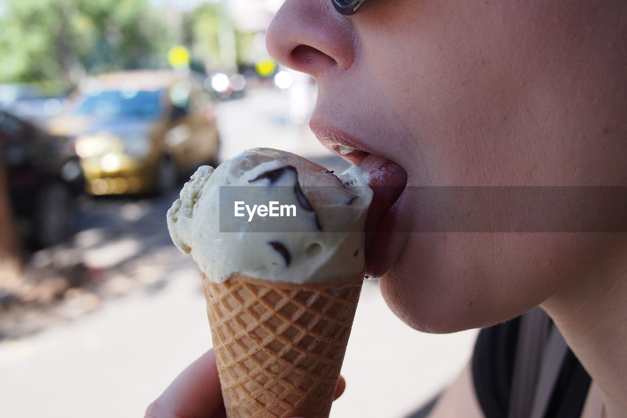 Close-up of young woman licking ice cream cone