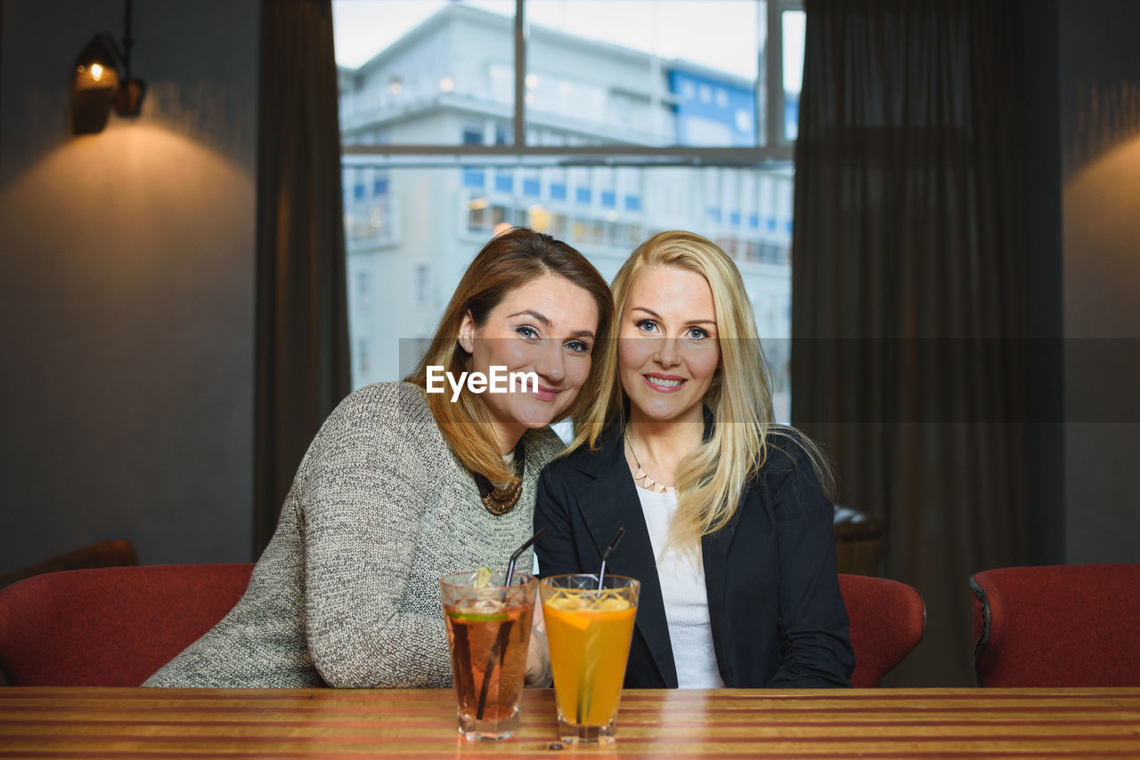 Adult girlfriends resting in bar