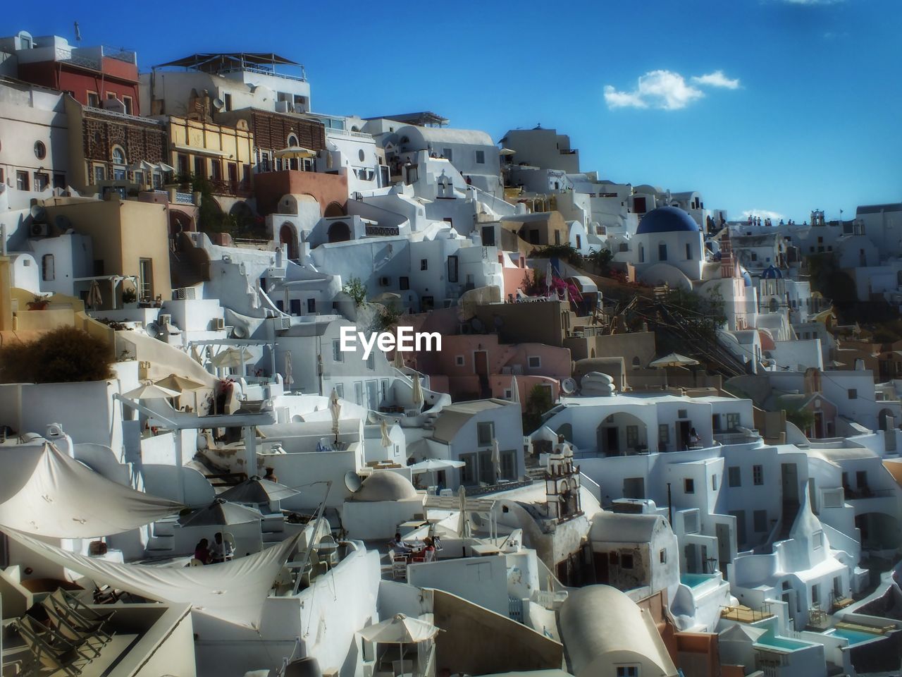 Aerial view of town against blue sky