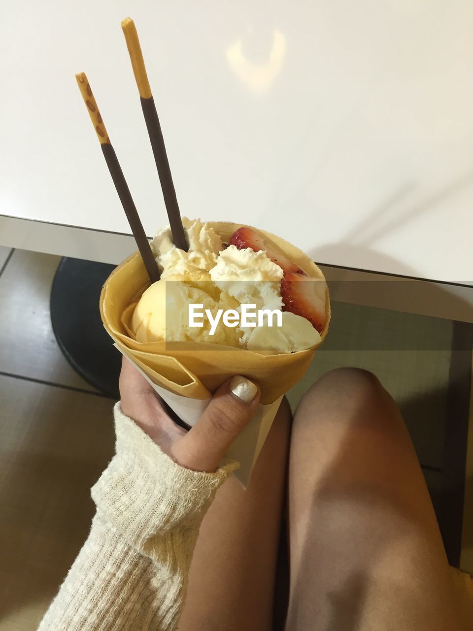 Midsection of woman holding ice cream