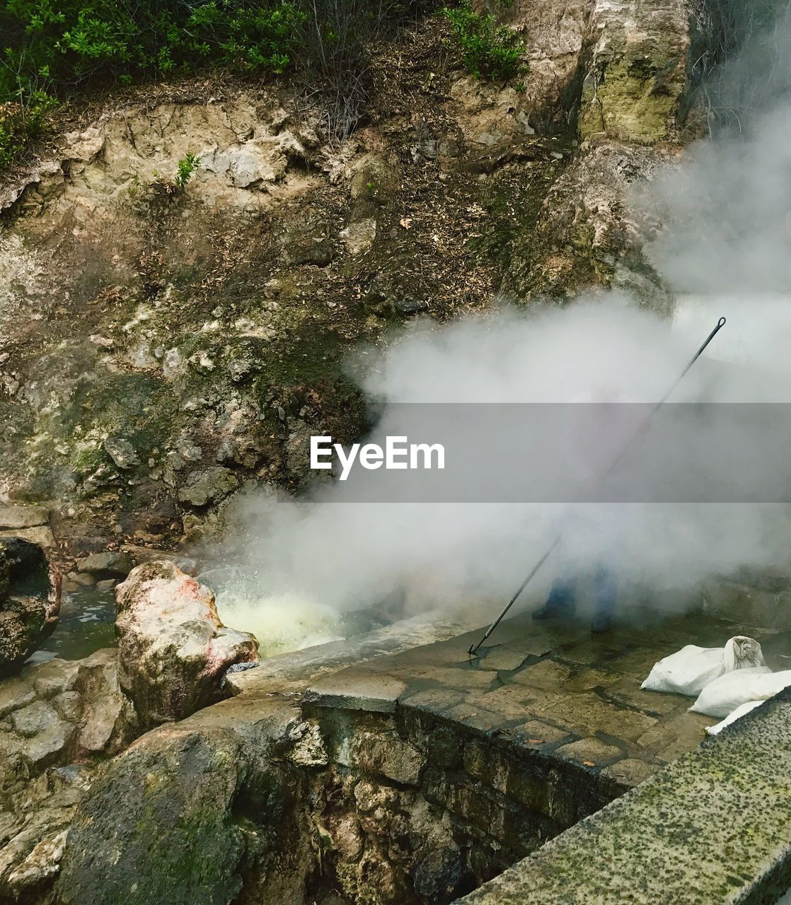 HIGH ANGLE VIEW OF SMOKE EMITTING FROM WATER