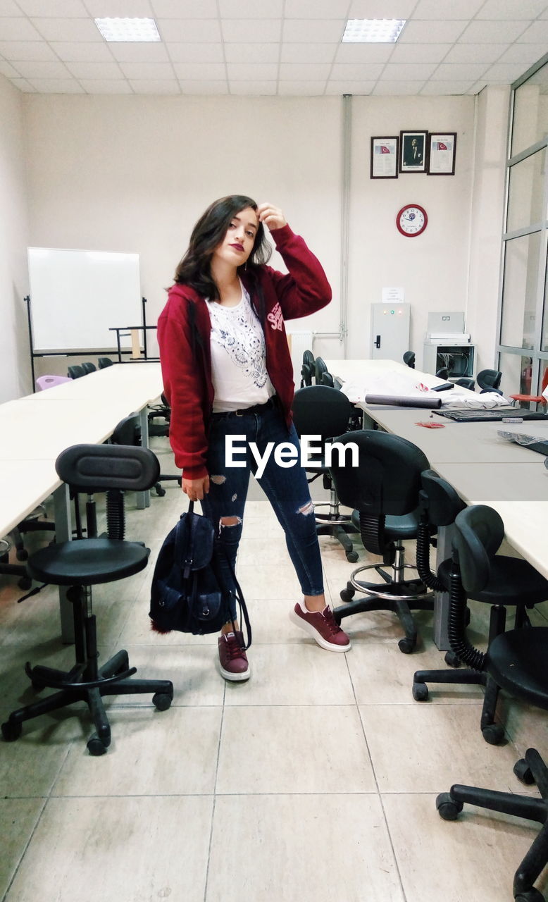 Full length of businesswoman standing in office