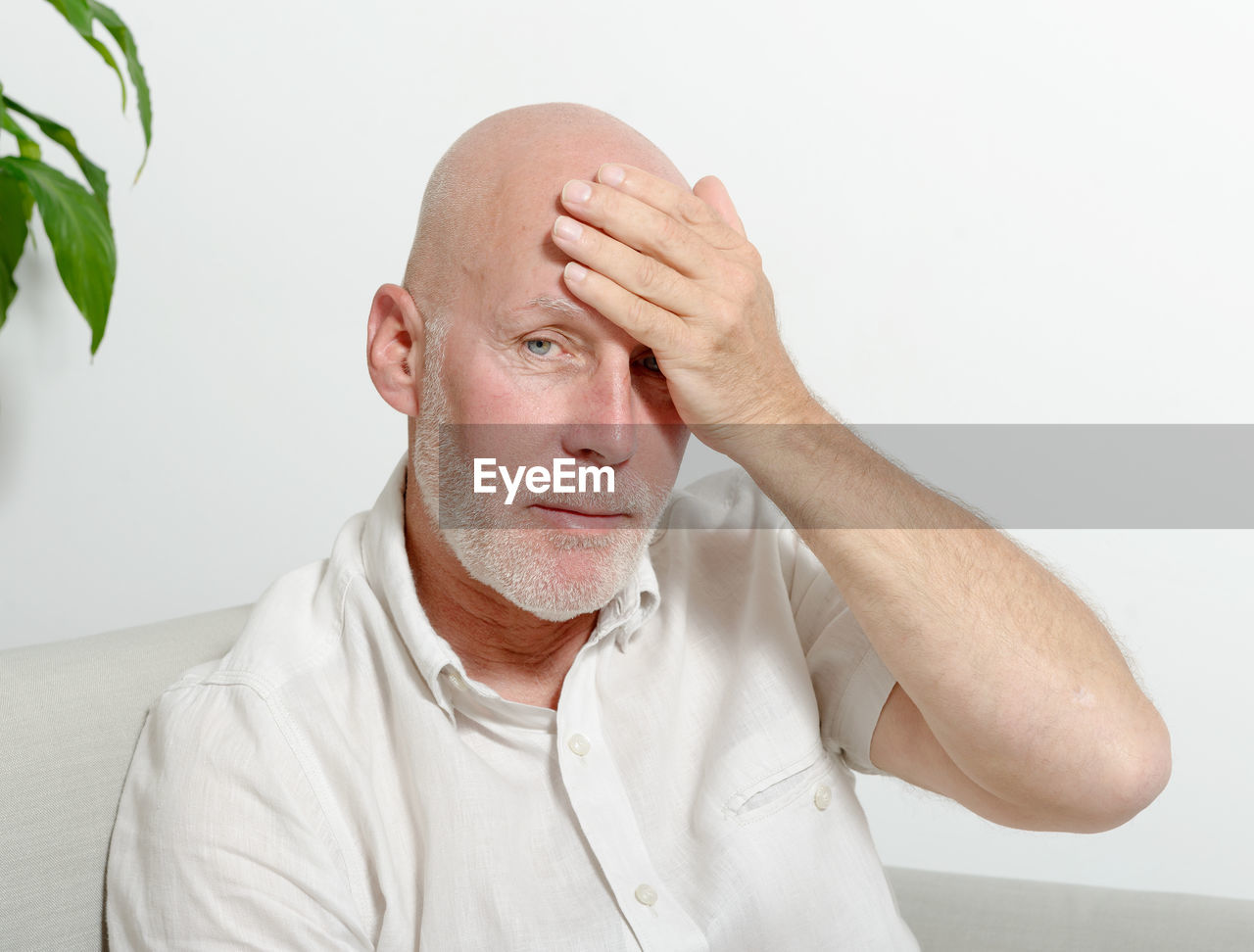 Portrait of man against white wall at home