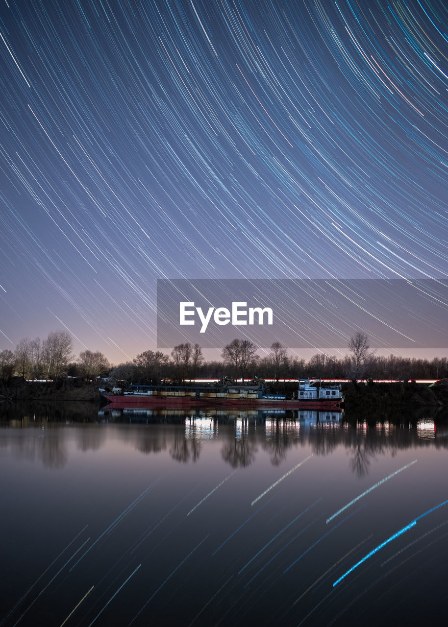 Scenic view of river against sky at night