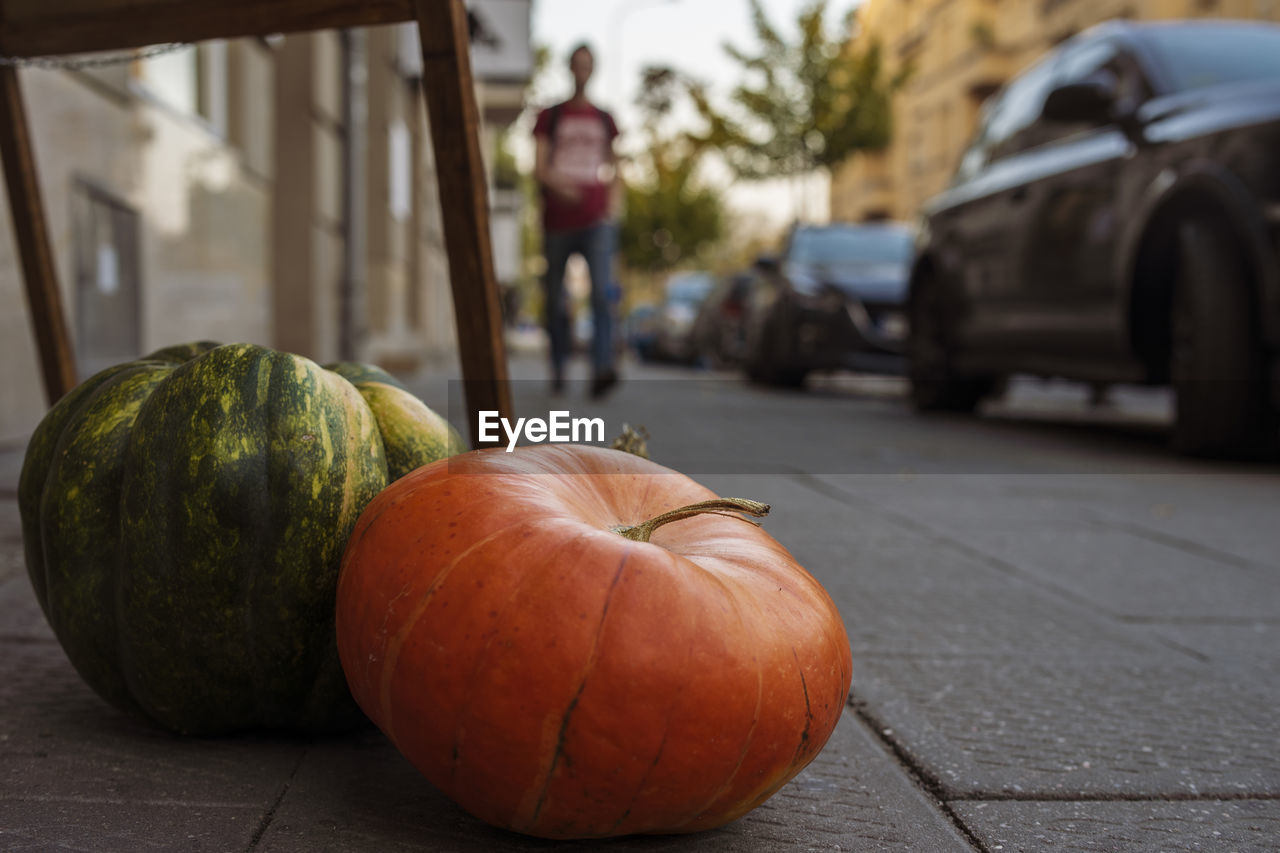 CLOSE-UP OF PUMPKINS ON TABLE AT STREET