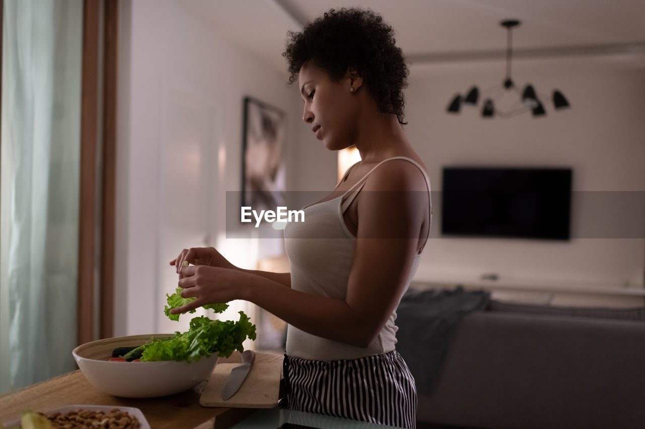 African american woman cooking healthy salad